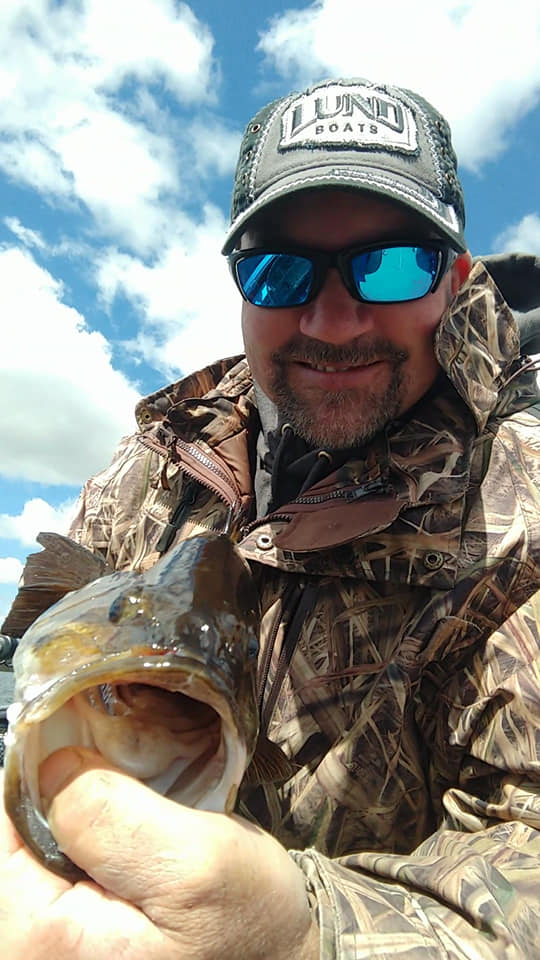 Chuck Roehl holding a walleye